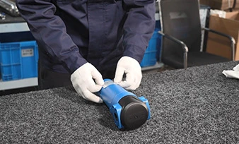 An operator applying a product label to a filter housing