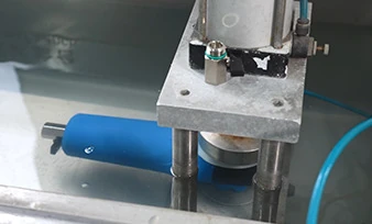 A filter undergoing a water-bath leakage check at a partner workshop