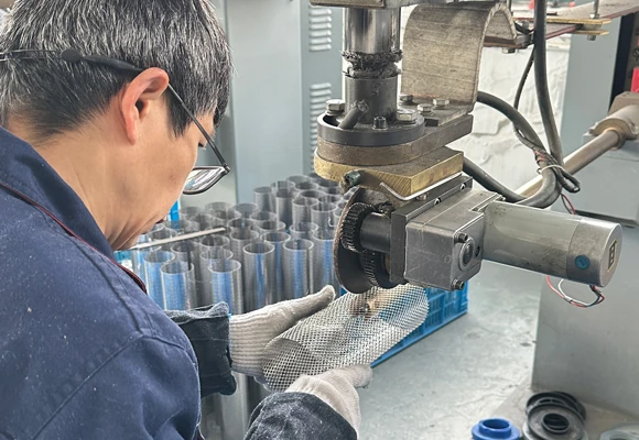 Welding the seam of a perforated filter support at a partner workshop